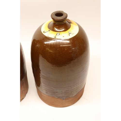 1041 - Two J.P. Appleby flagons, both with split treacle glaze, initialled 'JPA', H32cm max
Bradley's Shipp... 