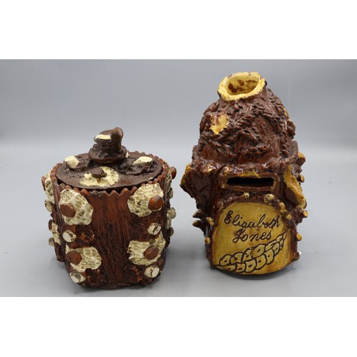 1012 - Barkware tobacco jar with alternate coloured appliques and bird finial, and a bark-ware money box, s... 