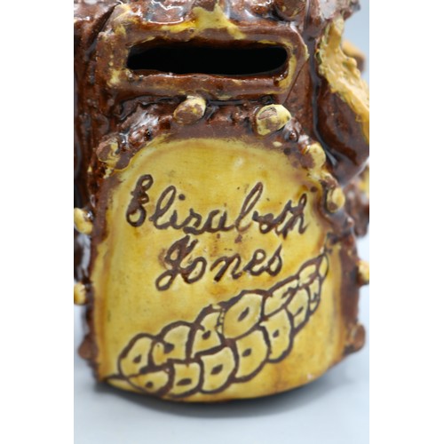 1012 - Barkware tobacco jar with alternate coloured appliques and bird finial, and a bark-ware money box, s... 
