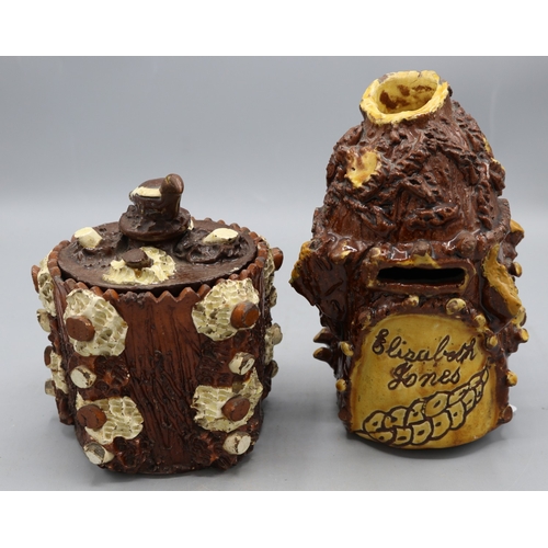 1012 - Barkware tobacco jar with alternate coloured appliques and bird finial, and a bark-ware money box, s... 
