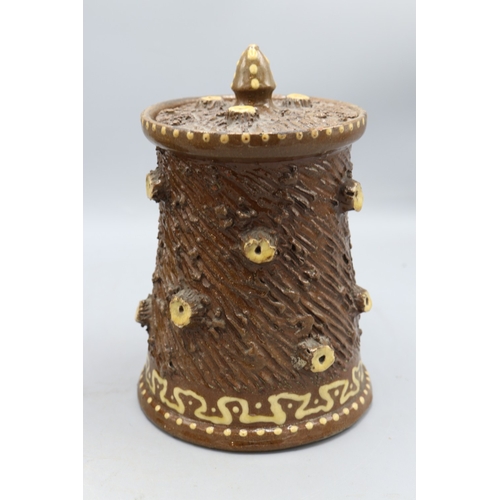 1019 - Three barkware tobacco jars of varying sizes, one in dark treacle type glaze with applied branch stu... 