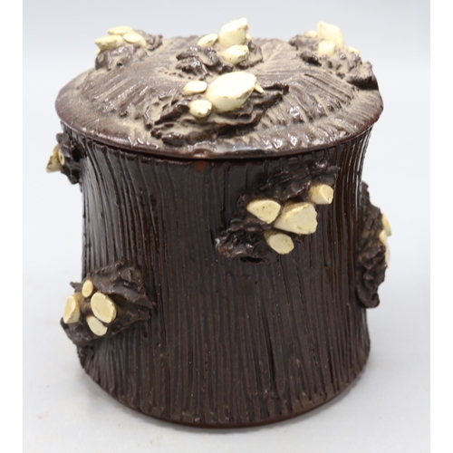 1019 - Three barkware tobacco jars of varying sizes, one in dark treacle type glaze with applied branch stu... 