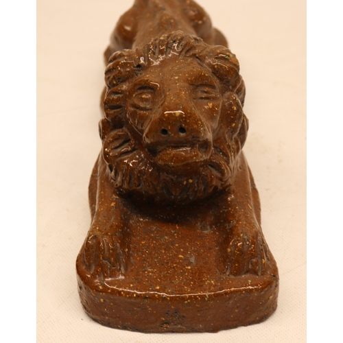 1077 - 19th century stoneware slat glazed lion atop plinth base and a stoneware dog figure with bowl on a s... 