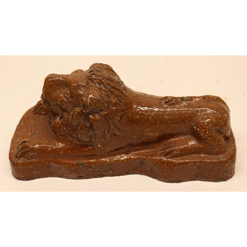 1077 - 19th century stoneware slat glazed lion atop plinth base and a stoneware dog figure with bowl on a s... 