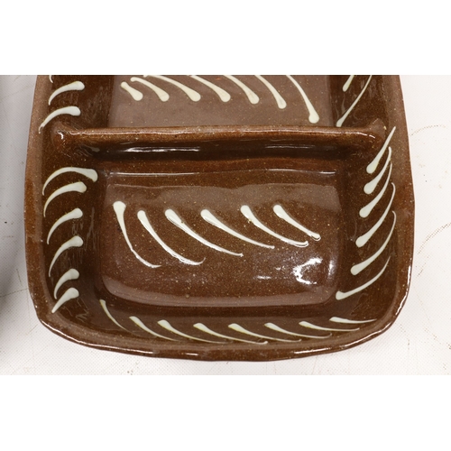 1076 - Two slipware baking dishes with central divisions, dashed contrasting pattern, max W32cm
Bradley's S... 