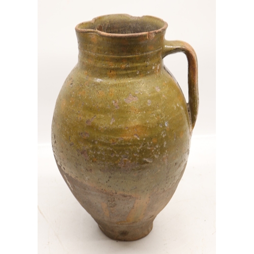 1075 - 18th Century terracotta squat baluster water jug with green glazed and incised ribbing, possibly con... 