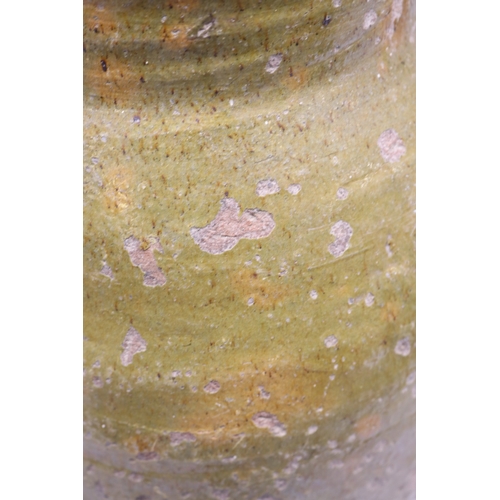 1075 - 18th Century terracotta squat baluster water jug with green glazed and incised ribbing, possibly con... 