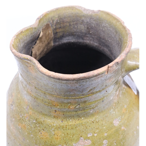 1075 - 18th Century terracotta squat baluster water jug with green glazed and incised ribbing, possibly con... 