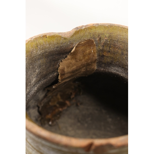 1075 - 18th Century terracotta squat baluster water jug with green glazed and incised ribbing, possibly con... 