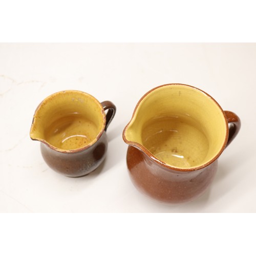 1029 - Five Yorkshire slipware jugs, yellow internal glaze, of varying sizes, in the manner of Isaac Button... 