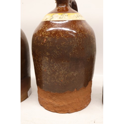 1046 - Four J.P. Appleby slipware flagons, treacle glazed, necked cylindrical form, three initialled 'JPA' ... 
