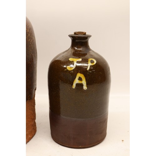 1046 - Four J.P. Appleby slipware flagons, treacle glazed, necked cylindrical form, three initialled 'JPA' ... 