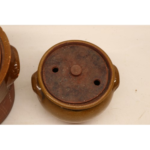 1056 - Two Yorkshire slipware crocks or cooking pots, one cylindrical and the other squat baluster, both pa... 