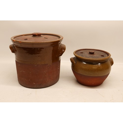 1056 - Two Yorkshire slipware crocks or cooking pots, one cylindrical and the other squat baluster, both pa... 