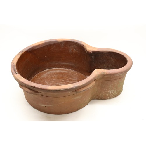 1067 - Large terracotta key hole shaped pot, glazed inner, two handles to each side, L63cm
Bradley's Shippi... 