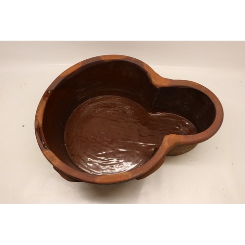 1067 - Large terracotta key hole shaped pot, glazed inner, two handles to each side, L63cm
Bradley's Shippi... 