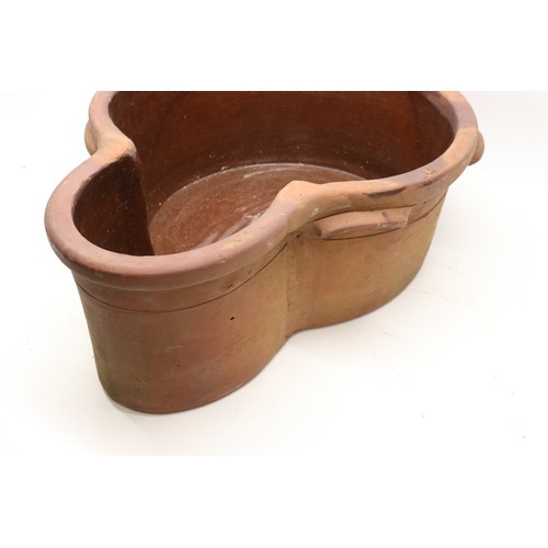 1067 - Large terracotta key hole shaped pot, glazed inner, two handles to each side, L63cm
Bradley's Shippi... 