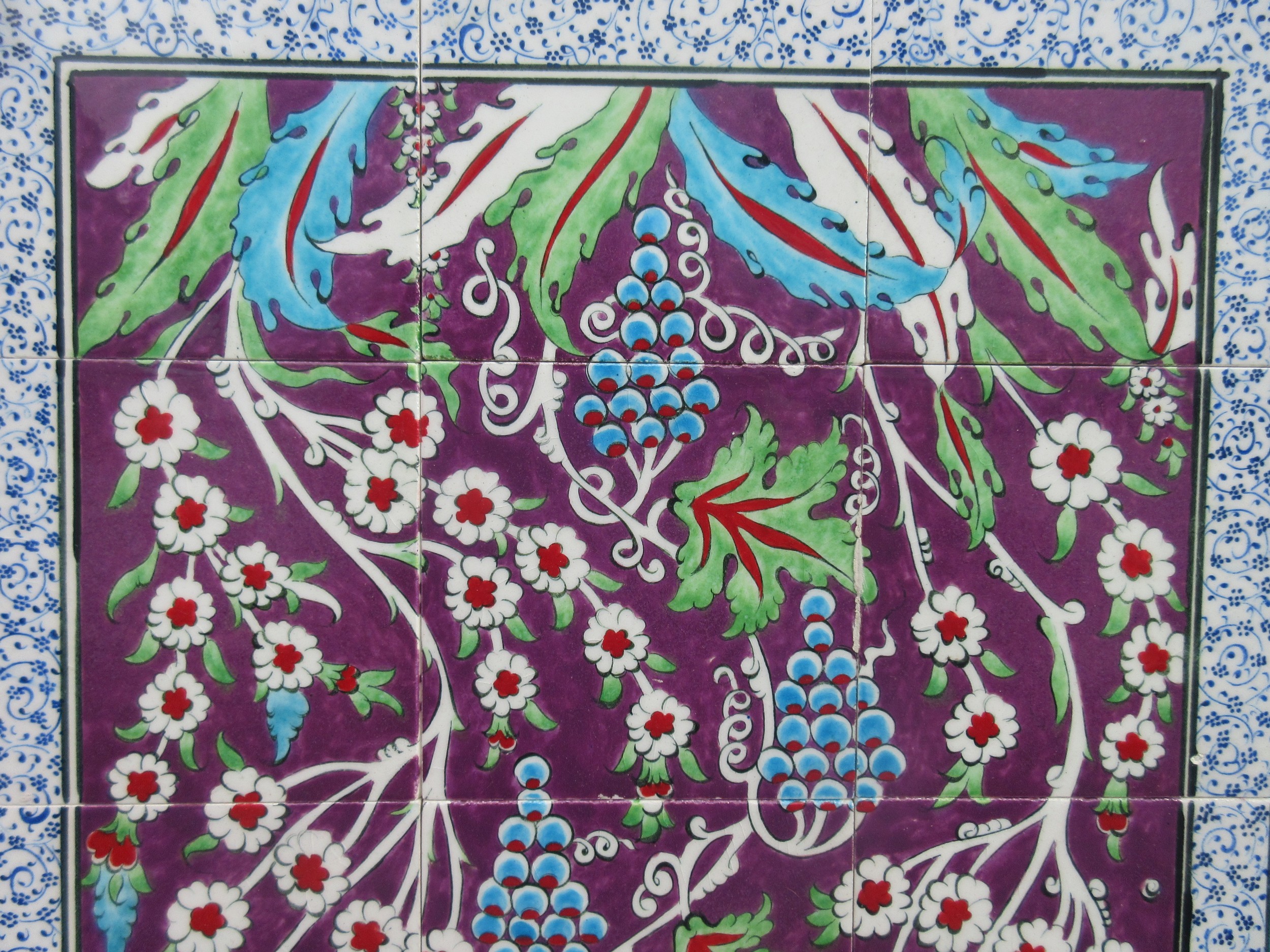Four framed pieces of Isnic ceramics tiles, with repeating detail ...