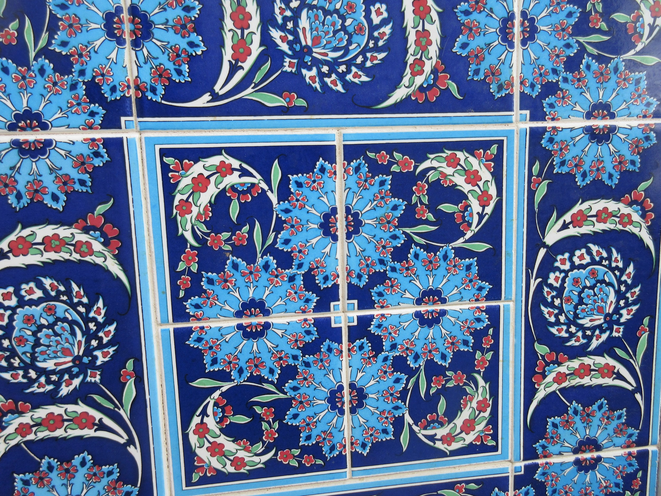 Four framed pieces of Isnic ceramics tiles, with repeating detail ...