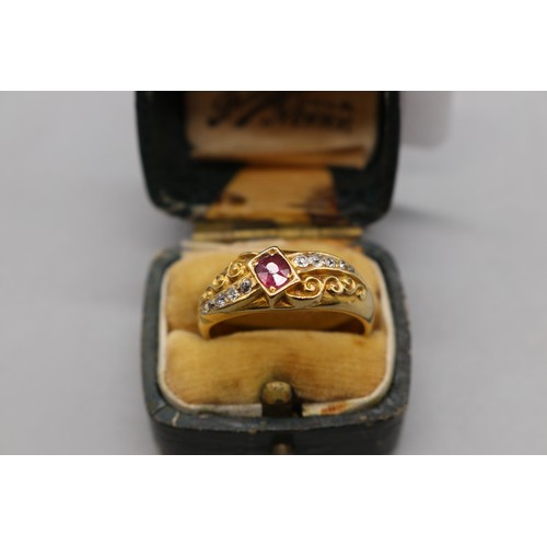 4 - Late 19th-century 18ct yellow gold ruby and diamond ring with scroll detailing, featuring one oval-c... 