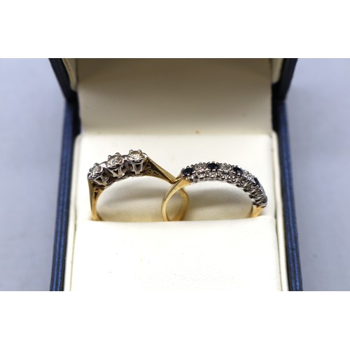 14 - Two mid century gold rings featuring 1x hallmarked 18ct yellow gold diamond trilogy ring approximate... 