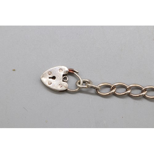18 - Mixed silver and white metal items comprising a hallmarked silver curb link bracelet with padlock cl... 