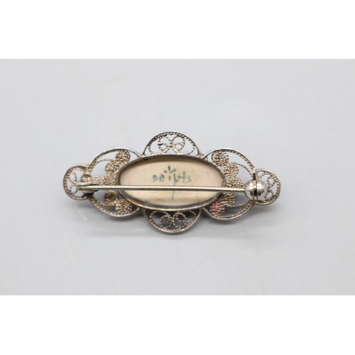20 - Arts and Crafts Movement hammered brooch, thought to be 800 silver, set with opalite, accompanied by... 