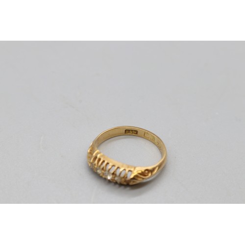 21 - A 5 stone claw set eternity ring stamped 18ct yellow gold with 5 diamond head note, 1 small diamond ... 