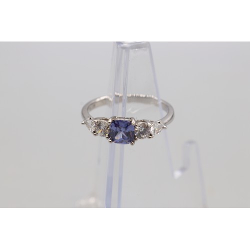 22 - Contemporary sterling silver five-stone ring set with tanzanite and cubic zirconia. Features a centr... 