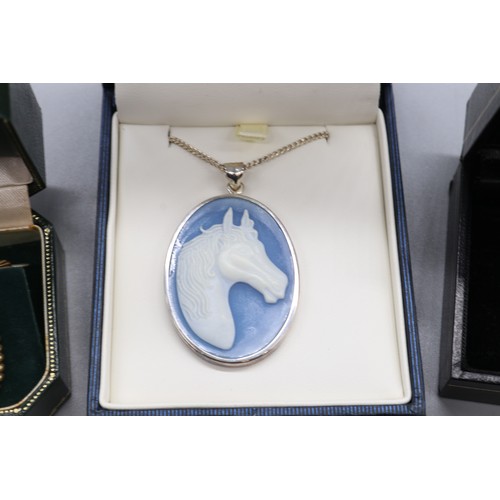 23 - Mixed metals, comprising a stamped sterling silver large blue oval cameo-style horse pendant with ch... 