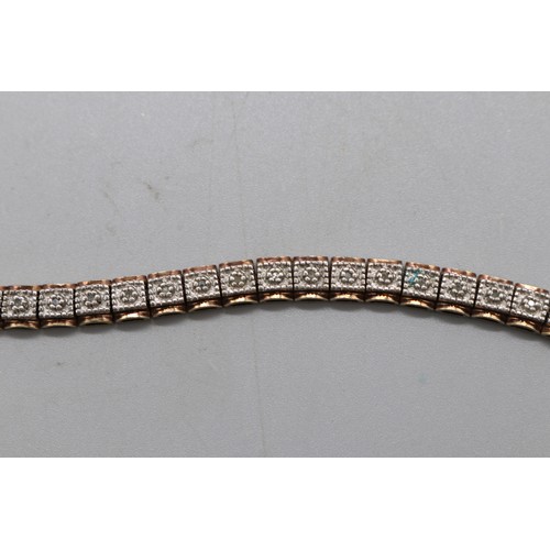 27 - Lot of three contemporary tennis bracelets comprising a two-tone gold-plated sterling silver diamond... 
