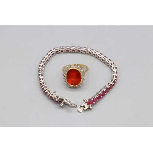 30 - Yellow and white metal oval cocktail ring set with a large vivid red-orange stone (colour resembling... 