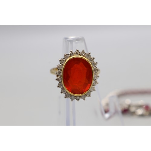 30 - Yellow and white metal oval cocktail ring set with a large vivid red-orange stone (colour resembling... 