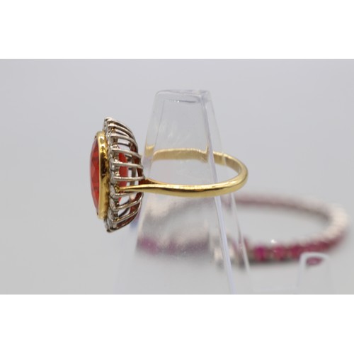 30 - Yellow and white metal oval cocktail ring set with a large vivid red-orange stone (colour resembling... 