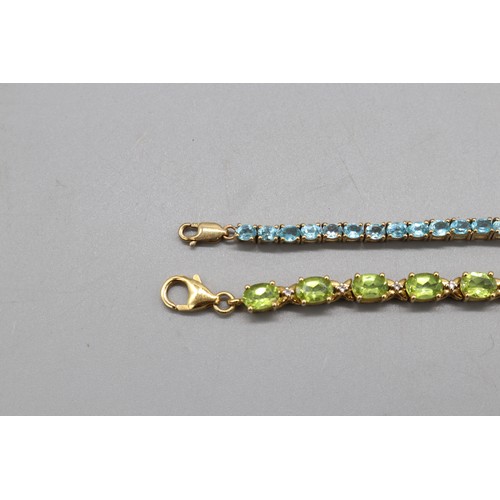 31 - Mixed lot of two contemporary sterling silver tennis bracelets set with semi-precious stones: one ye... 