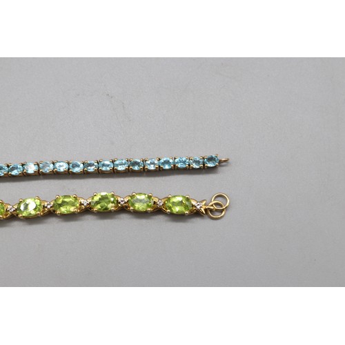 31 - Mixed lot of two contemporary sterling silver tennis bracelets set with semi-precious stones: one ye... 