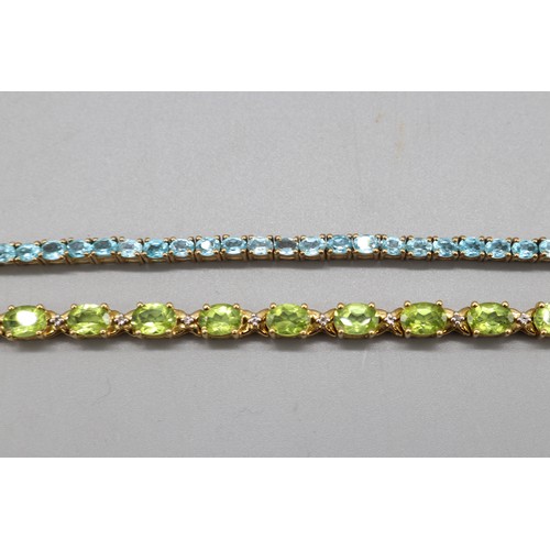 31 - Mixed lot of two contemporary sterling silver tennis bracelets set with semi-precious stones: one ye... 