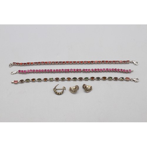 32 - Silver lot comprising three hallmarked sterling silver tennis bracelets: one round brilliant-cut rub... 