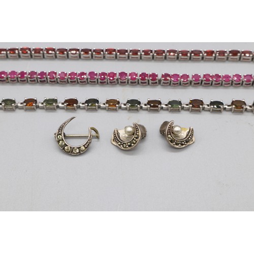 32 - Silver lot comprising three hallmarked sterling silver tennis bracelets: one round brilliant-cut rub... 