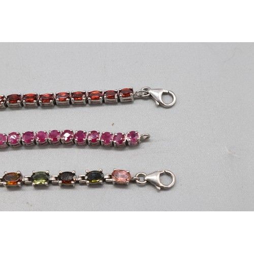 32 - Silver lot comprising three hallmarked sterling silver tennis bracelets: one round brilliant-cut rub... 