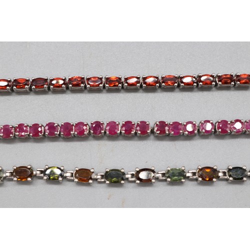 32 - Silver lot comprising three hallmarked sterling silver tennis bracelets: one round brilliant-cut rub... 