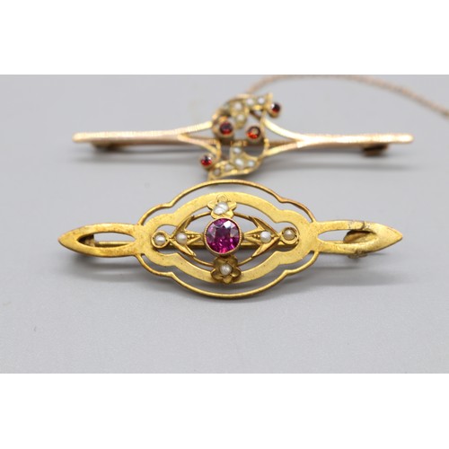 33 - Two gold brooches comprising one stamped 9ct rose gold bar brooch set with four garnets and seed pea... 