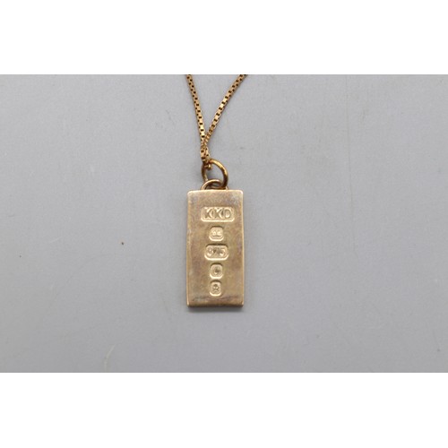 37 - 9ct yellow gold hallmarked 10g ingot pendant on a 9ct stamped yellow gold box chain, total weight 14... 