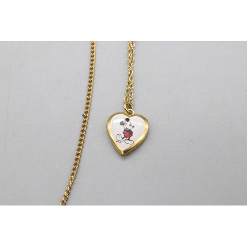41 - Mixed plated metal lot comprised of yellow metal mickey mouse heart locket on 16