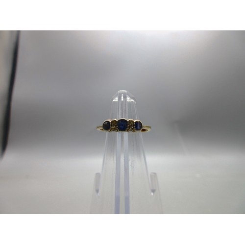 48 - 18ct yellow gold sapphire and diamond bezel-set trilogy ring, comprising three pale blue sapphire st... 