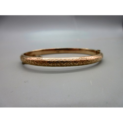 49 - Hallmarked 9ct rose gold engraved hinged bangle with safety chain, weight 6.19g; and a 9ct yellow go... 