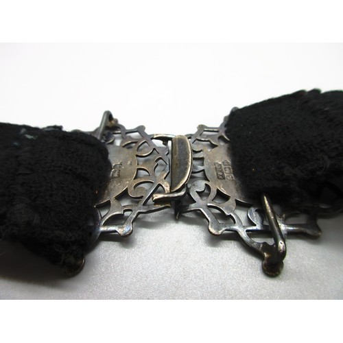 50 - One silver and fabric nurses’ belt with hallmarks on the reverse and hand-engraved scrollwork on a h... 