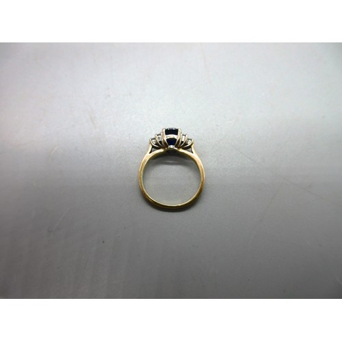 53 - Hallmarked 18ct yellow gold sapphire and diamond ring, 1 large oval faceted sapphire with trefoil 22... 