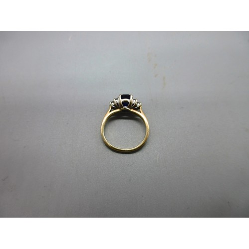 53 - Hallmarked 18ct yellow gold sapphire and diamond ring, 1 large oval faceted sapphire with trefoil 22... 