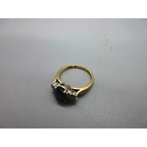 53 - Hallmarked 18ct yellow gold sapphire and diamond ring, 1 large oval faceted sapphire with trefoil 22... 